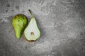 The two halves of the pear on concrete background
