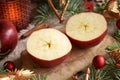 Two halves of a red apple with a star in the middle with Christmas ornaments Royalty Free Stock Photo