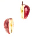 Two halves of a red ripe apple flying in the air isolated on white Royalty Free Stock Photo