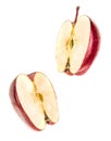 Two halves of a red ripe apple flying in the air isolated on white Royalty Free Stock Photo