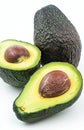 Fresh Avocado Halves With Pits on a White Background