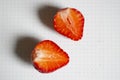 Two halves of ripe strawberries on a white background. white background in a dark dot and strawberries cut into halves. Royalty Free Stock Photo