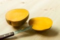 Two halves sliced exotic fruit mango with knife on the wooden table board. Royalty Free Stock Photo