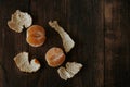 Two halves of a tangerine with a peeled skin laid out around lie on a wooden background. Royalty Free Stock Photo