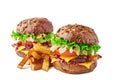 Two hamburgers with cereal buns and french fries on white Royalty Free Stock Photo