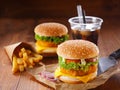 Two hamburgers, fried potatoes and soda Royalty Free Stock Photo