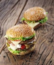 Two hamburgers on old table. Royalty Free Stock Photo