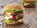 Two hamburgers on old wooden table. Royalty Free Stock Photo