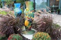 Two hand-painted ballet slippers tucked into ornamental grasses and flowers, downtown Saratoga Springs, New York, 2018