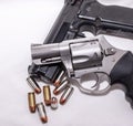 Two handguns, a 40 caliber pistol and a 357 magnum revolver with 40 caliber bullets Royalty Free Stock Photo