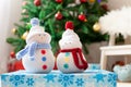 Two handmade snowmen with Christmas background on white fur Royalty Free Stock Photo