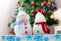 Two handmade snowmen with Christmas background on white fur Royalty Free Stock Photo