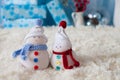 Two handmade snowmen with Christmas background on white fur Royalty Free Stock Photo