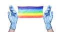 Two hands in blue rubber gloves, protective medical mask LGBT community flag color white background isolated closeup, latex gloves Royalty Free Stock Photo