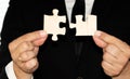 two hands of businessman to connect couple puzzle piece with sky background Royalty Free Stock Photo