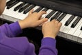 Two hands of a child playing the piano. Selective focus on children& x27;s fingers and piano keys for playing the piano. Royalty Free Stock Photo