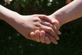 Two hands clasped together in a sign of friendship and support Royalty Free Stock Photo