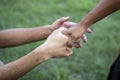 Two hands clasping in a gesture of support and connection outdoors Royalty Free Stock Photo