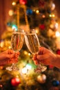 Two hands clink glasses with champagne, christmas Royalty Free Stock Photo