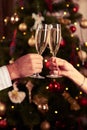 Two hands clinking champagne glasses over blurred New Year background Royalty Free Stock Photo