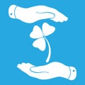 Two hands with Clover with three leaves sign icon on a blue bac