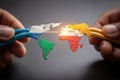 Two hands connect colored cables shaping a world map, symbolizing global connectivity and network communication Royalty Free Stock Photo