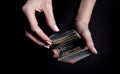 two hands with dollars. Closeup female hand giving money for something with isolated on black background,count, paying, shopping Royalty Free Stock Photo