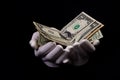 two hands with dollars. Closeup female hand giving money for something with isolated on black background,count, paying, shopping Royalty Free Stock Photo