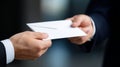 A close-up of hands exchanging a white envelope. This image captures the essence of communication and professionalism. Perfect for Royalty Free Stock Photo