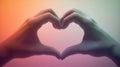Two hands forming a heart shape against a colorful gradient background. This image symbolizes love, unity, and compassion Royalty Free Stock Photo