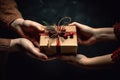 Two hands give two other hands a christmas gift box. Concept merry christmas and happy new year