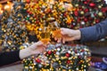 Two hands with glasses of champagne on a Christmas or New Year background Royalty Free Stock Photo