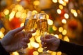 Two hands with glasses of champagne on a Christmas or New Year background Royalty Free Stock Photo