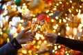 Two hands with glasses of champagne on a Christmas or New Year background Royalty Free Stock Photo