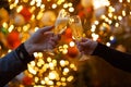 Two hands with glasses of champagne on a Christmas or New Year background Royalty Free Stock Photo