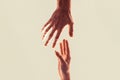 Two hands, helping arm of a friend, teamwork, vertical. Helping hand outstretched, isolated arm, salvation. Helping hand