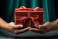 Two hands hold a Christmas gift box. Merry Christmas and Happy New Year concept. Royalty Free Stock Photo
