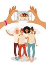 Two hands hold a martphone and take a photo of a group of teenage girls