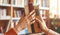 Hands holding a stack of old books in a library image photo Royalty Free Stock Photo