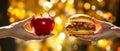 Two hands holding an apple and a hamburger Royalty Free Stock Photo
