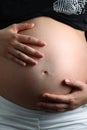 Two hands holding a beautiful pregnant belly Royalty Free Stock Photo