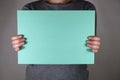 Two hands holding blue paper sheet Royalty Free Stock Photo