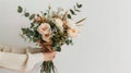 Two Hands Holding a Bouquet of Flowers