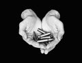 Two hands holding bullets isolated on black