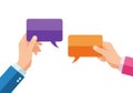 Two hands holding colorful speech bubbles for communication and ideas exchange Royalty Free Stock Photo