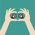 Two hands holding cute cat dog paw print. Love and care pet animals. Helping hand concept. Adopt, donate. Flat design.