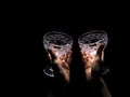 Two hands are holding empty wine glasses on a dark background 3 Royalty Free Stock Photo