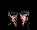 Two hands are holding empty wine glasses on a dark background 2 Royalty Free Stock Photo