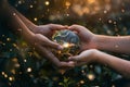 Two hands holding a globe with light shining through it Royalty Free Stock Photo