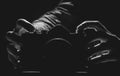 Two hands holding a hidden camera in black and white Royalty Free Stock Photo